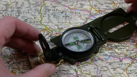 Traveler charting a course with map and compass Stock Footage