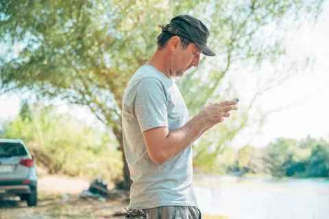 Traveler checking GPS navigation and messages on a smartphone during a road.. Stock-Fotos