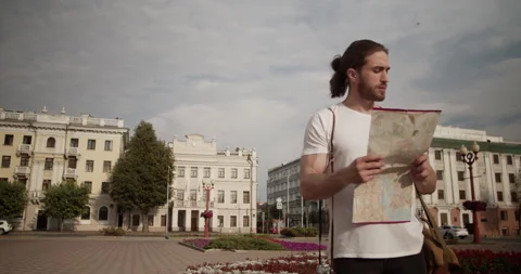 Traveler checking map on city square during trip Stock Footage 249785319