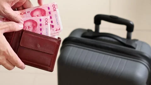Traveler counting banknotes while packing a suitcase for a holiday trip. Stock Footage 304832570