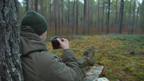 Traveler drinking tea in the forest Video stock 296283750