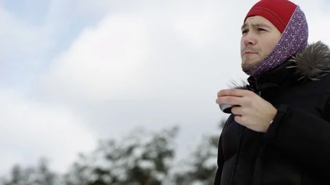 Traveler drinks tea at the view of winter sky Stock Footage 70809845