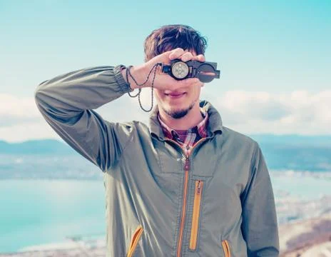 Traveler guy with compass Stock Photos
