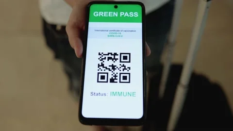 Traveler holding qr code digital green pass certificate for coronavirus vaccine Stock Footage 164677882