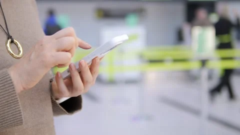 Traveler interacts with device in terminal Stock Footage 343842789