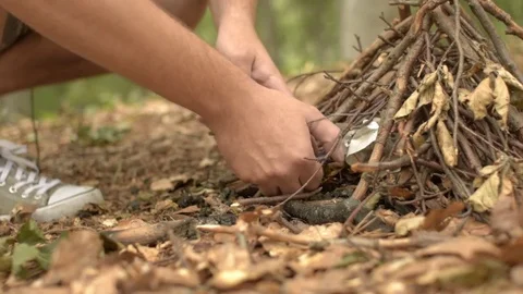 The traveler lights the fire using a lighter Stock Footage 79393109
