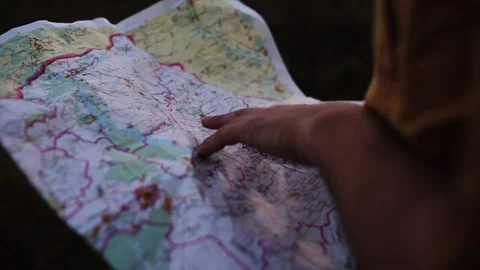 Traveler is looking for a destination on the map Stock Footage 86553203