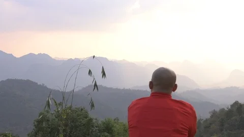 Traveler looking at mountain range view with sunset hazy sky cinemagraph Stock Footage 87761577