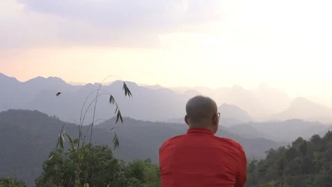 Traveler looking at mountain range view with sunset hazy sky cinemagraph Stock Footage 87762197