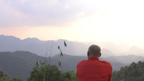 Traveler looking at mountain range view with sunset hazy sky Stock Footage 87763434