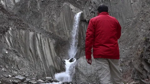 Traveler Looking at Waterfall 動画素材 303661177