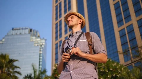 Traveler Man With Backpack Sightseeing In City At Sunset With Camera Видео 84947223