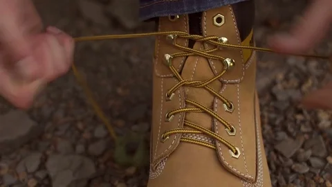 Traveler man hands lacing up trekking shoes. Stock Footage