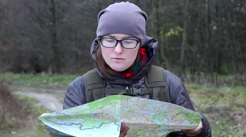 Traveler with a map looking for direction in the forest Stock Footage 68995563