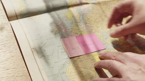 Traveler maps out a future Paris trip using notes for budget, flights, and Stock Footage 337491068