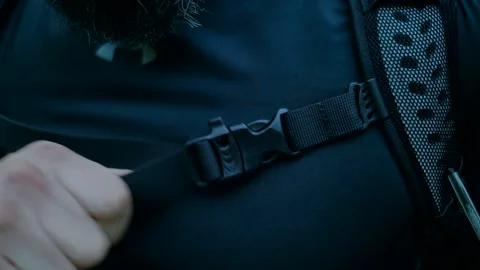 The traveler pulls back the strap of the backpack Stock Footage 138691086