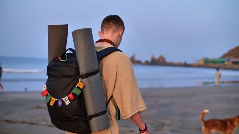 Traveler on the shore with a backpack Stock Footage 263531518