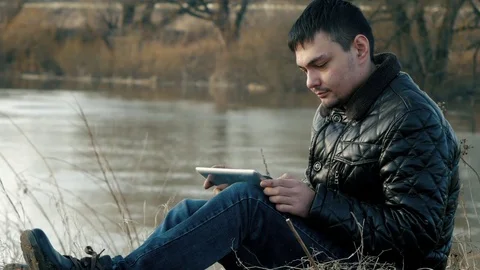 The traveler to the shore with the tablet Stock Footage 74024341