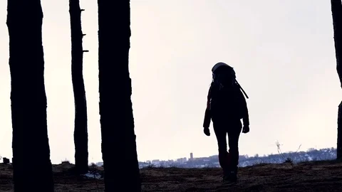 The traveler silhouette. female with backpack hiking in forest. Slow motion Stock Footage