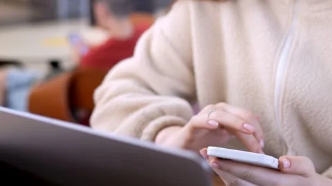 Traveler uses smartphone while waiting at airport Stock Footage 340960506