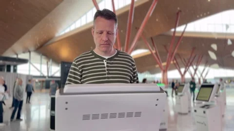Traveler Using Self Check-In Kiosk at Pittsburgh Airport Stock Footage 318848936
