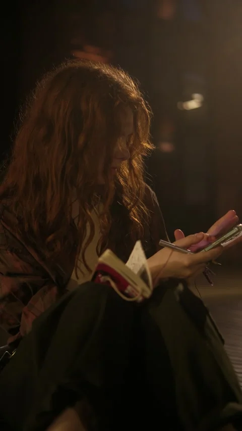 Traveler writes travel notes in a notebook uses the phone, cinematic Video stock 313886801