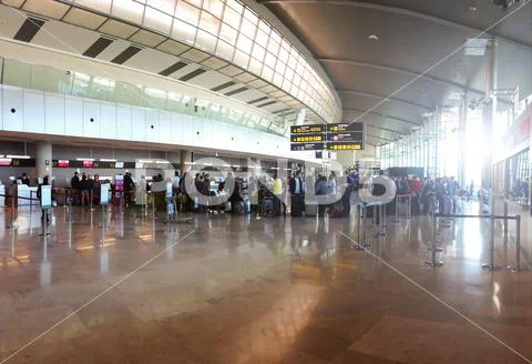 Travelers checking in at an airline counter in the Manises Airport in Valenci Stock Photos