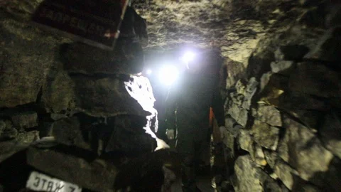 Travelers explore the dark cave Stock Footage 103182970