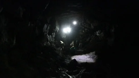 Travelers explore the dark cave Stock Footage 103183123
