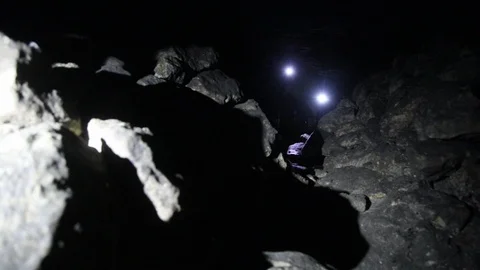 Travelers explore the dark cave Stock Footage 103183264