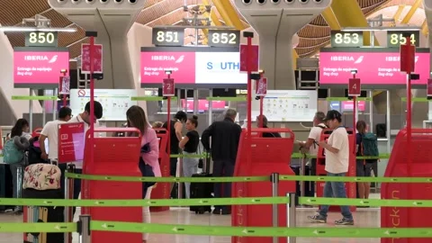 Travelers use self check-in machines at Iberia desks in Madrid-Barajas T4 Stock Footage 305161072