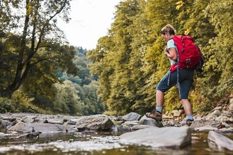 Traveling with backpack concept image. Backpacker female in trekking boots .. Stock Photos