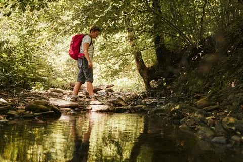 Traveling with backpack concept image. Backpacker female in trekking boots .. Stock Photos