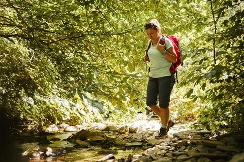 Traveling with backpack concept image. Backpacker female in trekking boots .. Stock Photos