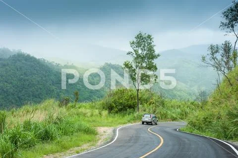 Traveling by car on mountain road. Stock Photos