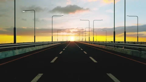 Traveling down an empty highway towards a beautiful sunset 스톡 동영상 280060773