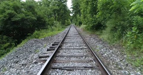 Traveling down freight train tracks, point of view, rural industrial area, Video stock 133734382