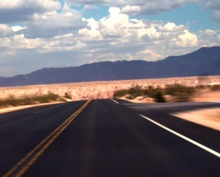 Traveling Fast Along a Desert Road Stock Footage