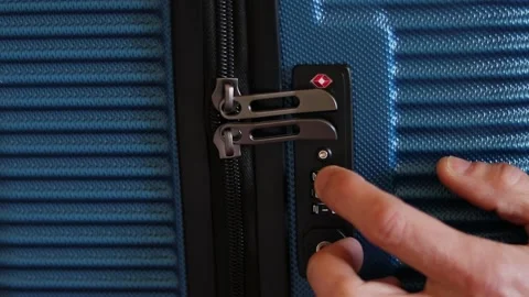 Traveling, a man opens a suitcase with a combination lock by entering security Video stock 229900277