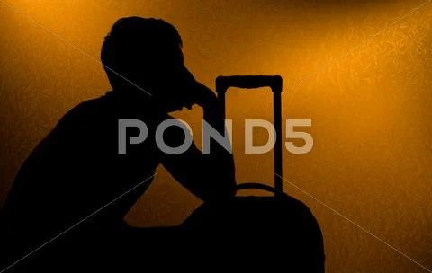 Traveling - silhouette of man and suitcase Stock Photos