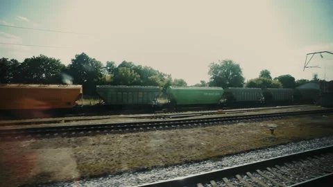 Traveling by train. A passenger train passes by a small industrial town. Stock Footage 165741589