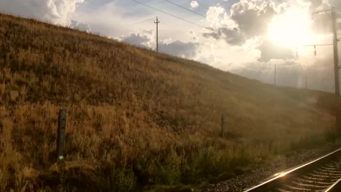 Traveling by train. View out of train of beautiful nature and sunset Stock Footage 161396619