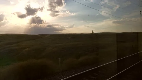 Traveling by train. View out of train of beautiful nature and sunset Stock Footage 161396834