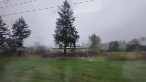 Traveling by train, view from the window during the rain, drops on glass Stock Footage 297240424