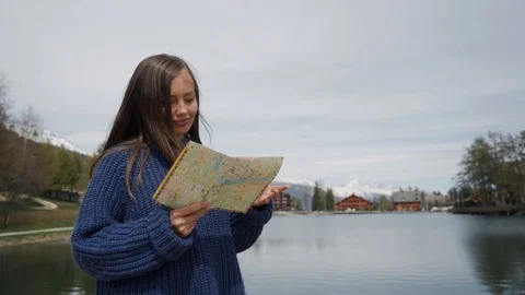 Traveling Using Map. Beautiful long-hair woman holding paper map in hands and 스톡 동영상 116526235