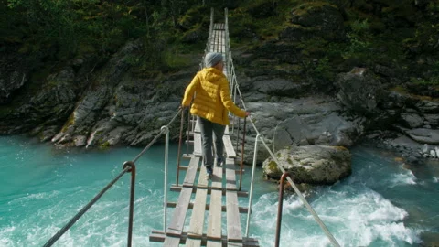 Traveller walk over suspension bridge in Norway Stock-Footage 241655341