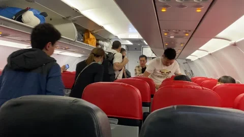Traveller walking at aisle on plane after arriving at Phuket Airport. Stock Footage 265281114