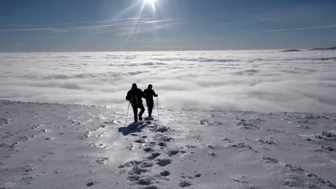 Travellers With Backpacks Make a Winter Hike Above the Clouds With a View of 動画素材 71208820