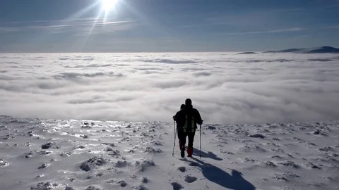 Travellers With Backpacks Make a Winter Hike Above the Clouds With a View of 動画素材 71208839