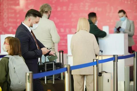 Travellers standing in queue Stock Photos